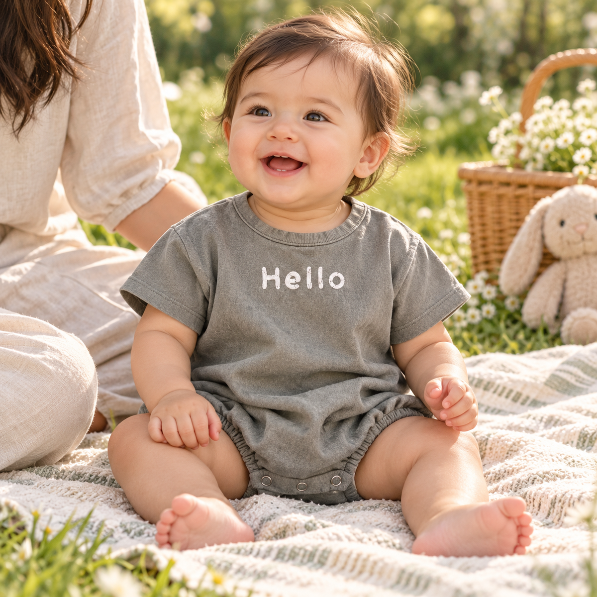 Baby wearing gray Hello bubble romper in an editorial setting