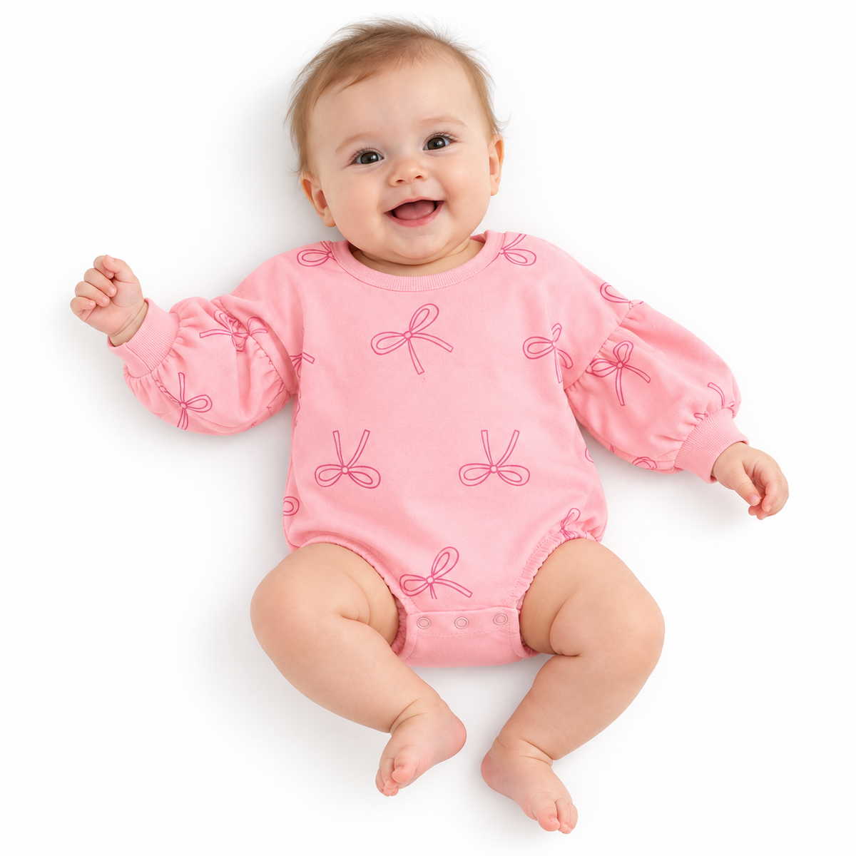 Baby modeling pink bow-print bodysuit on pure white