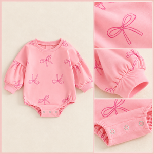 Framed pink bow bodysuit flat lay with print and snap details