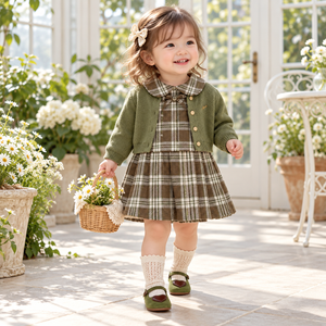 Girl wearing matcha cardigan and plaid dress in spring editorial