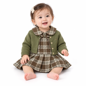 Baby modelling the plaid dress and matcha green cardigan set on pure white