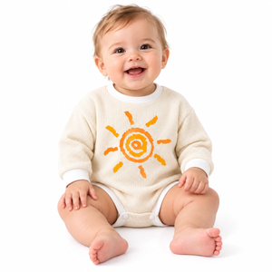 Baby model wearing beige big sun waffle romper on pure white background