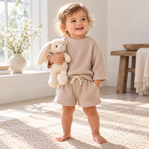 Toddler wearing Apricot waffle top and shorts in an editorial