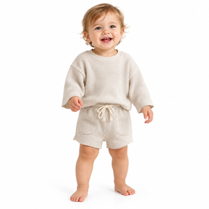 Apricot waffle two-piece on baby against clean white background